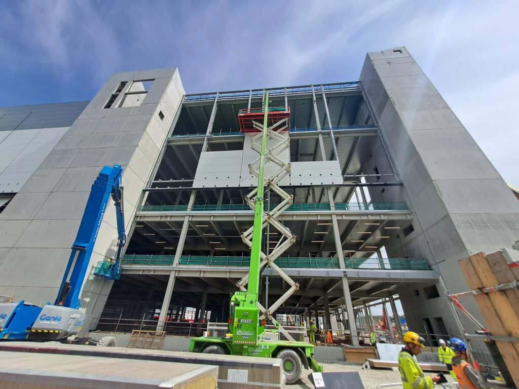 Construction site with cranes and workers.