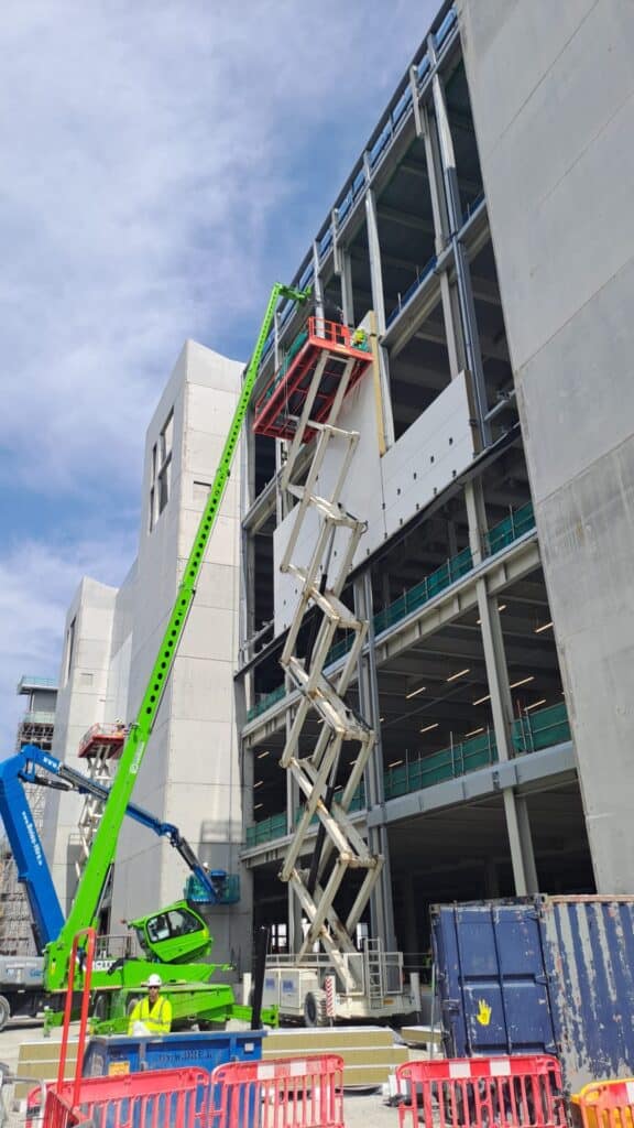 Construction site with cranes lifting materials