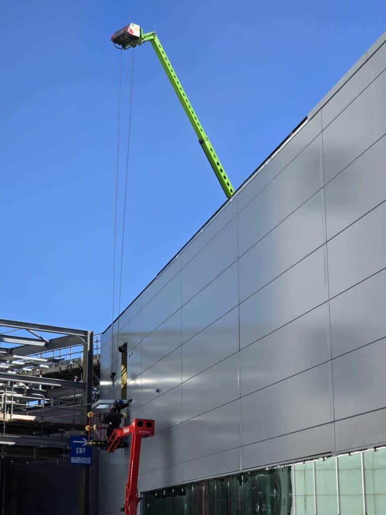 Construction crane working on building exterior